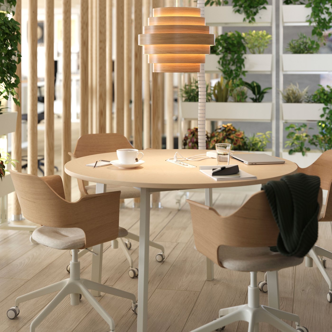 A round birch veneer/white MITTZON conference table in the dining room