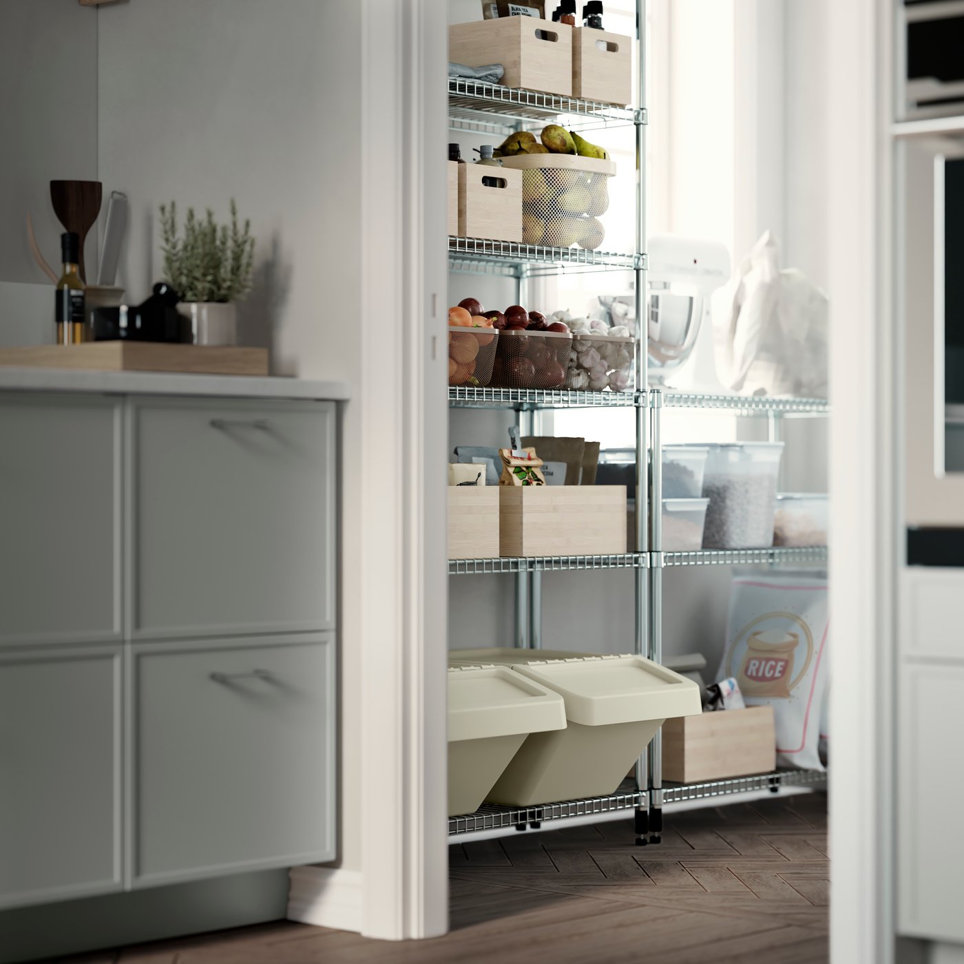 A pantry with OMAR shelving units, storing wooden and plastic boxes, glass jars, fruit baskets, and dry food.