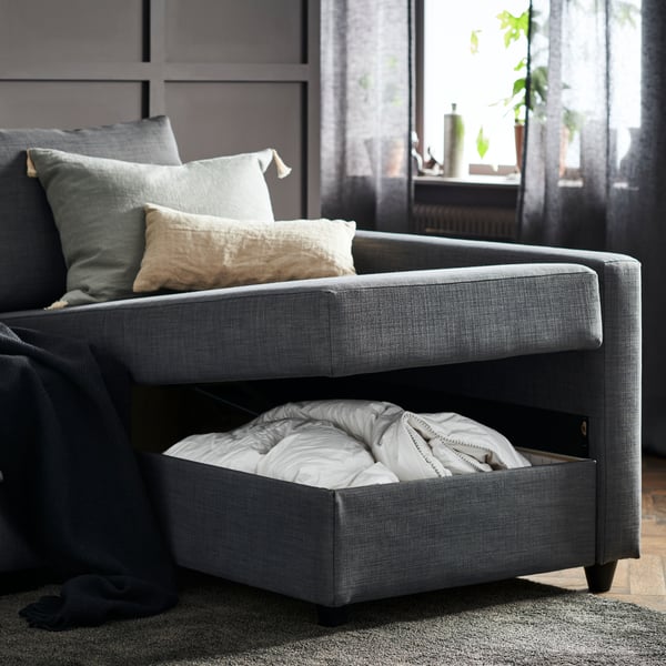 A Skiftebo dark grey KLAGSHAMN corner sofa-bed with storage in the living room