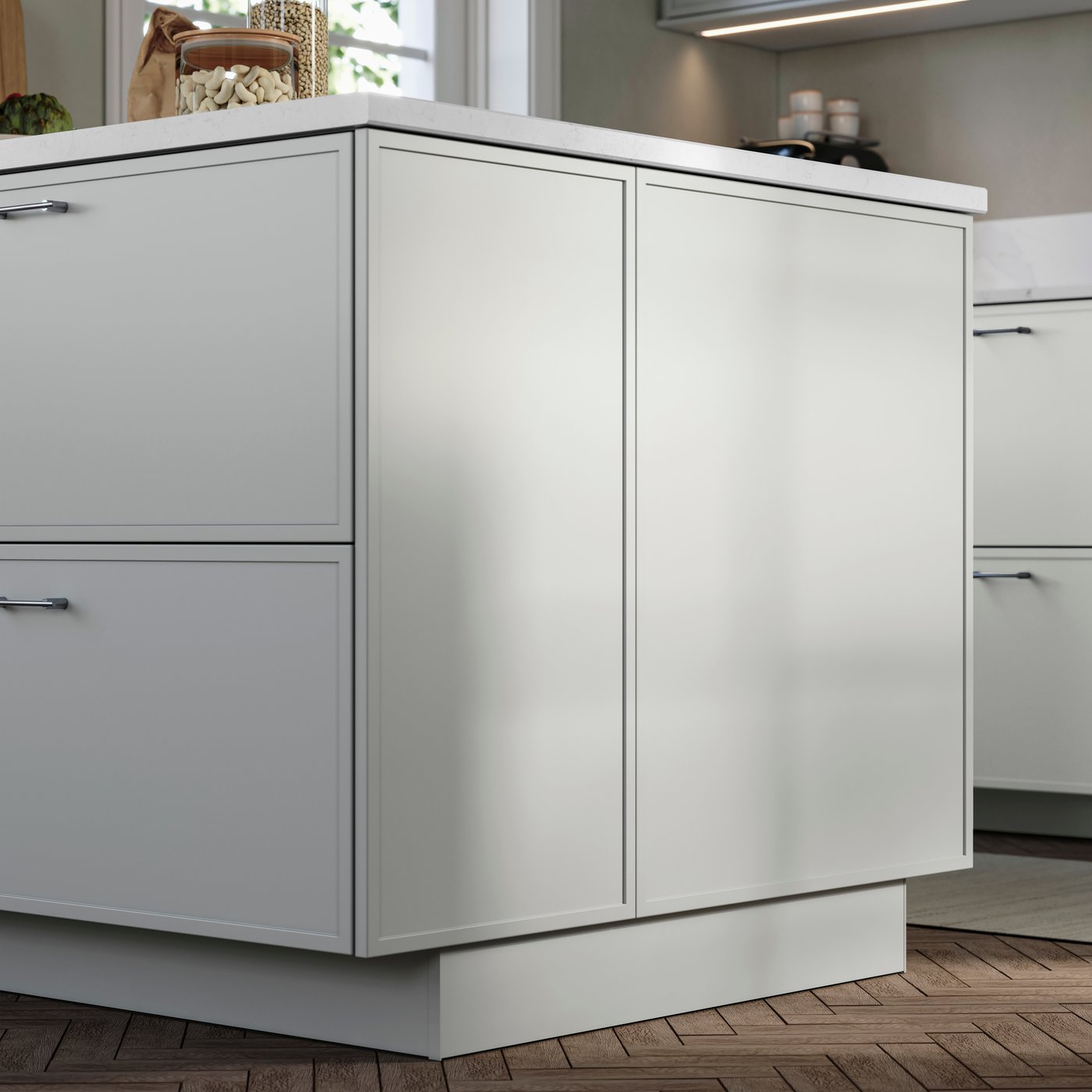 ASPUDDEN light grey fronts and cover panels on a kitchen island, in a modern kitchen with fishbone patterned wooden floors.