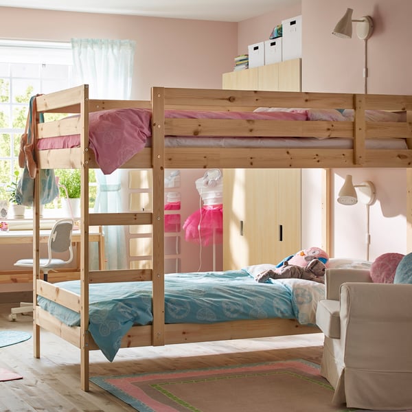 A pine MYDAL bunk bed frame in the bathroom