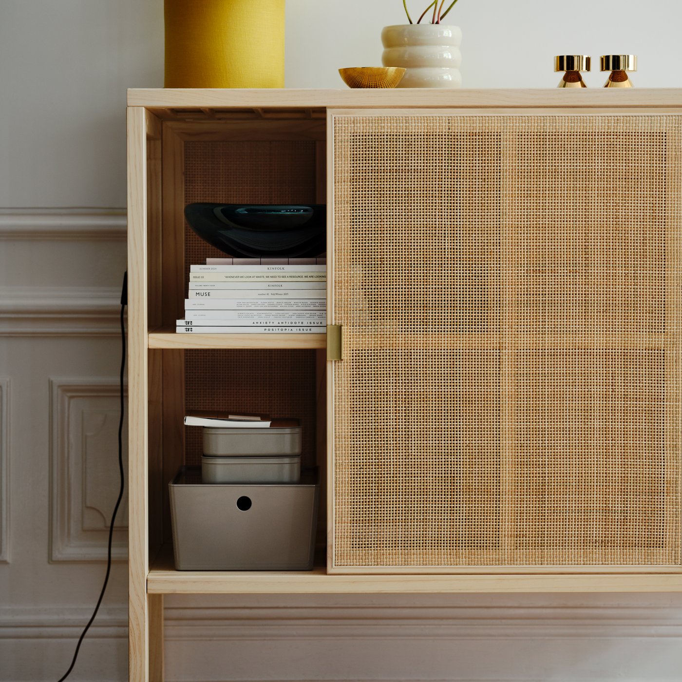 Grey-beige HARVMATTA storage box inside a rattan IKEA STOCKHOLM 2025 cabinet.