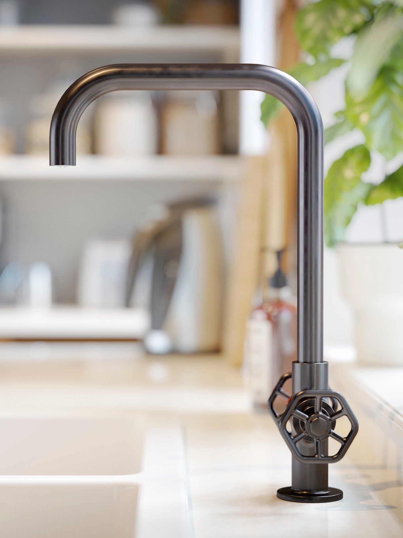 A close-up of an IKEA GAMLESJÖN dual-control kitchen mixer tap in brushed black metal.