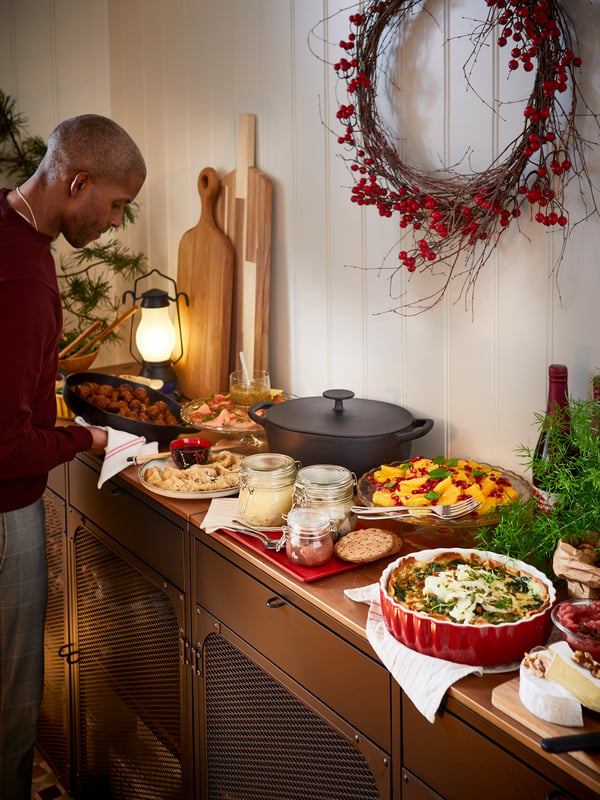 Swedish Christmas buffet table with meatballs, herring and other IKEA food in servingware including VARDAGEN casserole.
