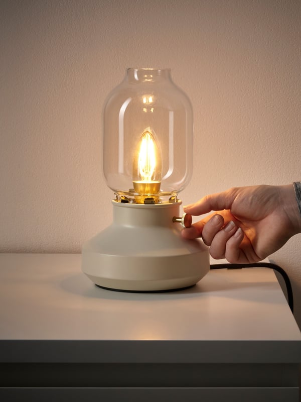 A dimmable beige TÄRNABY table lamp in the bedroom