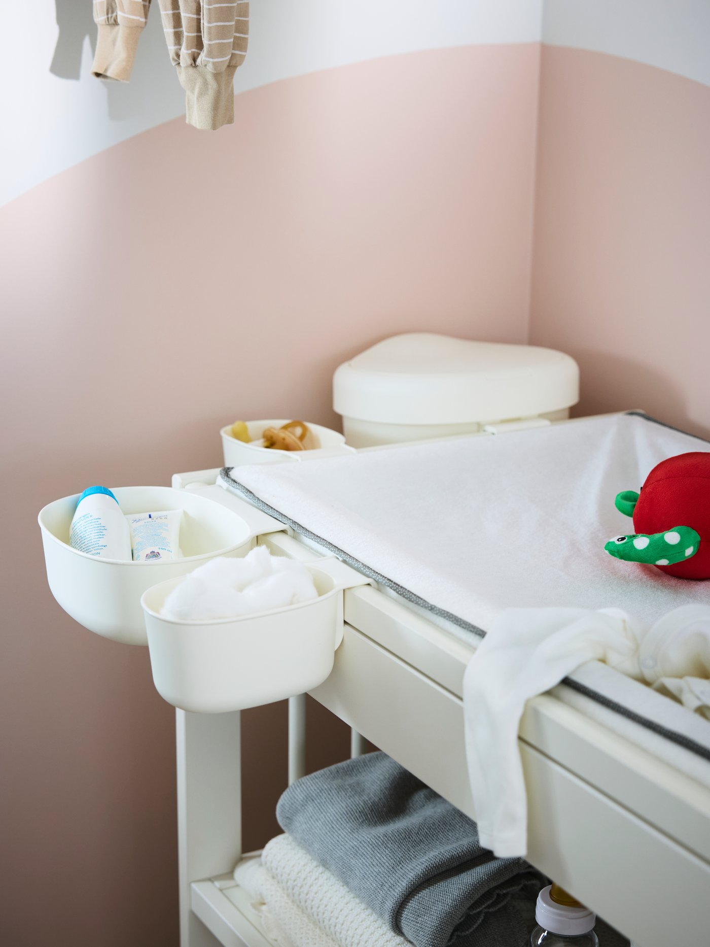 Close-up of GULLIVER changing table with diapers, pacifiers, lotion, blankets and other things needed for a baby.
