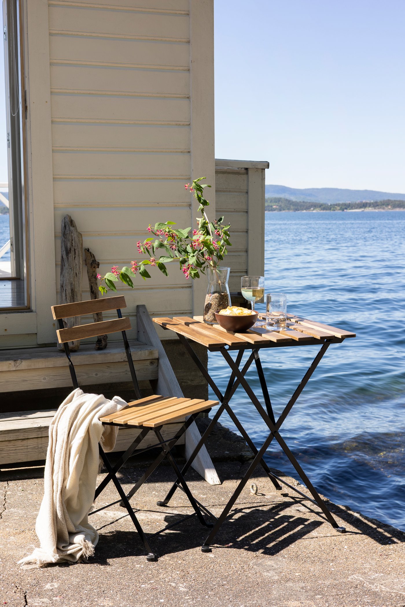 A black/light brown stained TÄRNÖ table, outdoor outside
