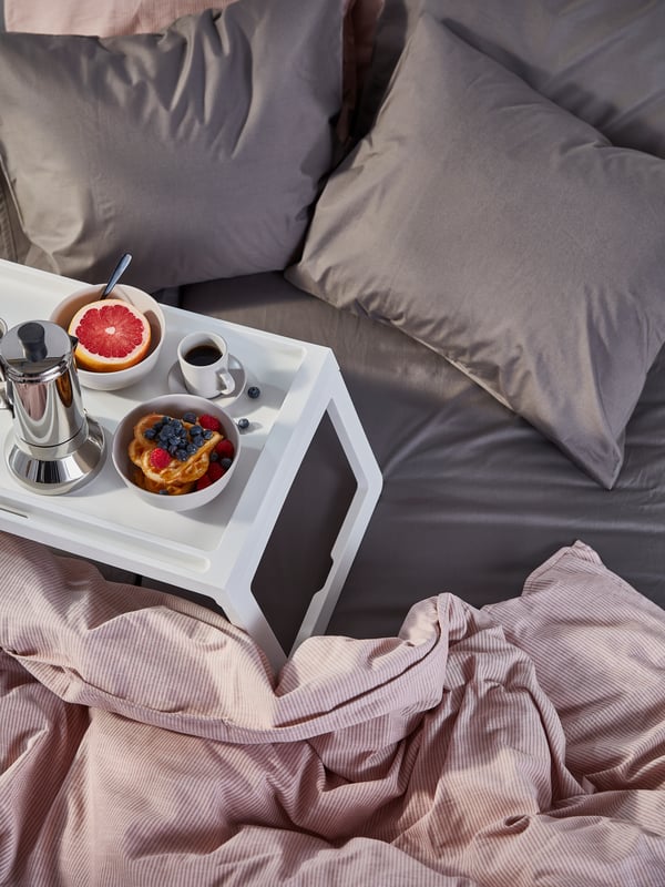 tray with breakfast on bed