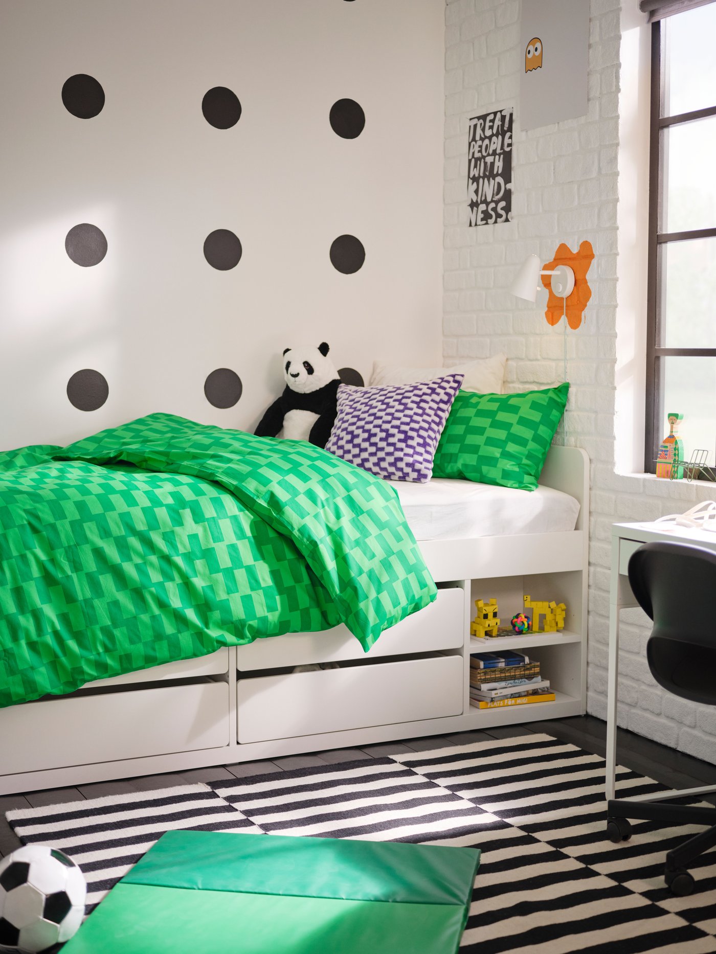 A green PLUFSIG folding gym mat in the childrens room