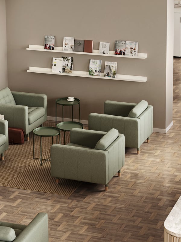 Green LANDSKRONA armchairs with GLADOM tray tables between them and picture ledges holding journals on the wall.