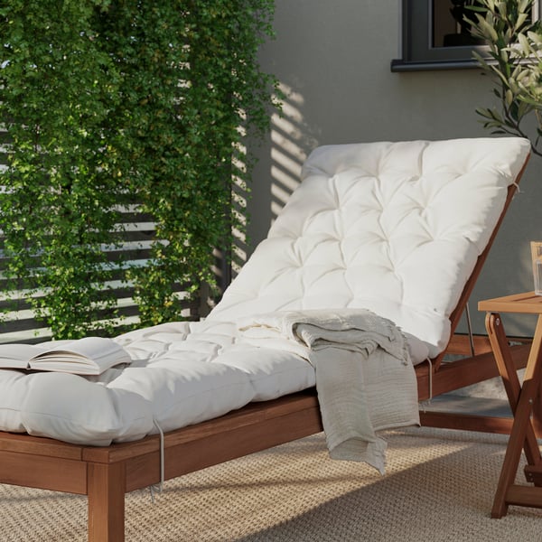 An outdoor light brown stained NÄMMARÖ sun lounger