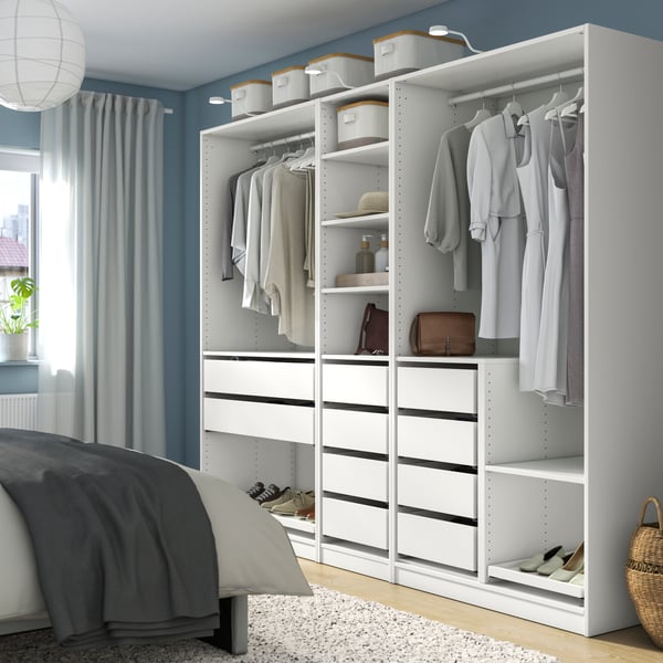 A white PAX wardrobe combination with drawers and clothes rails