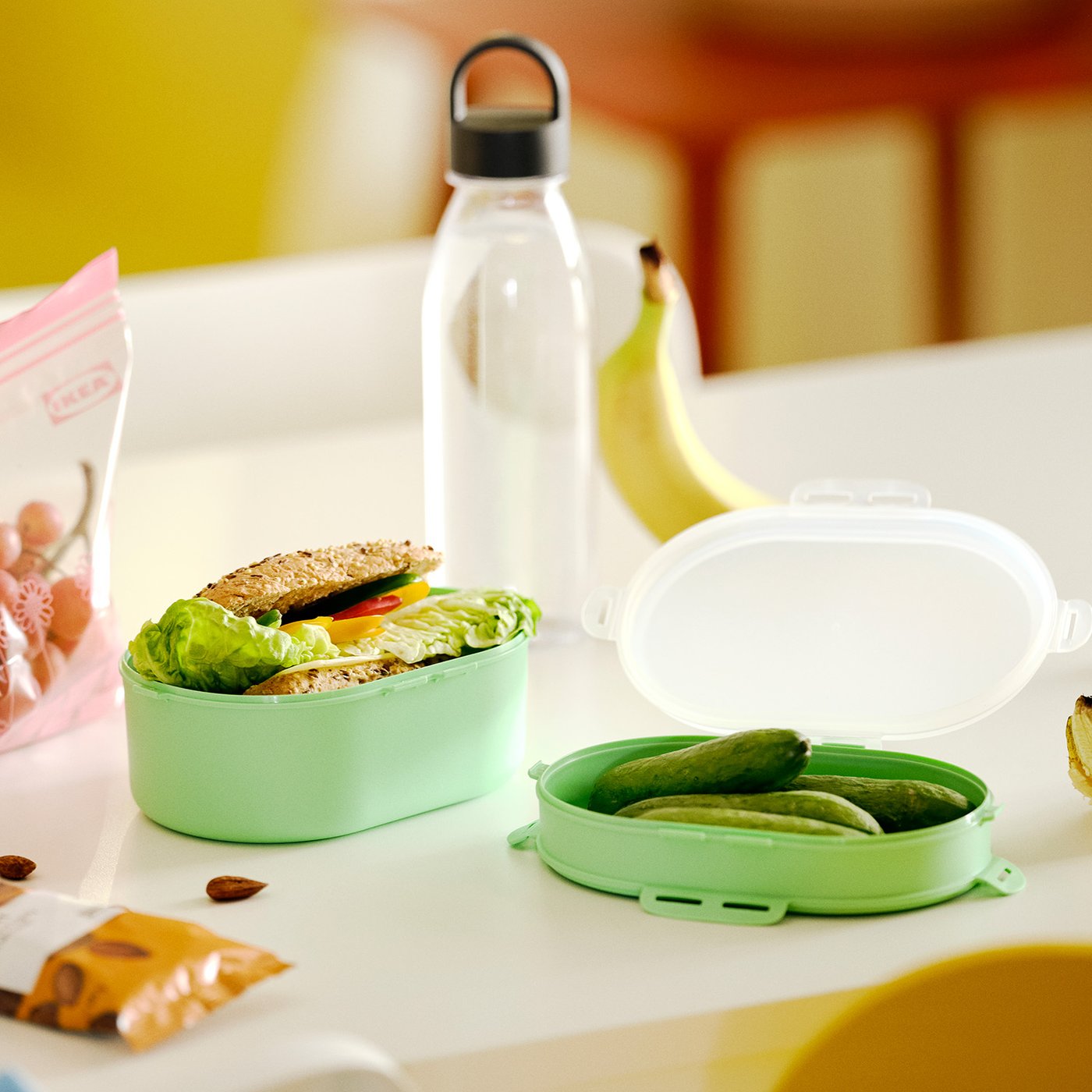 A light green UTBJUDA stackable lunch box for dry food in the dining room