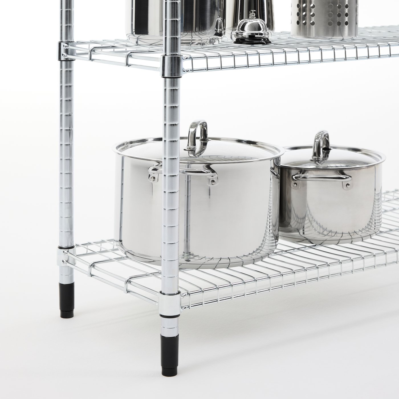 A close-up of an OMAR shelving unit in galvanised steel, stacked with pots in shiny steel.