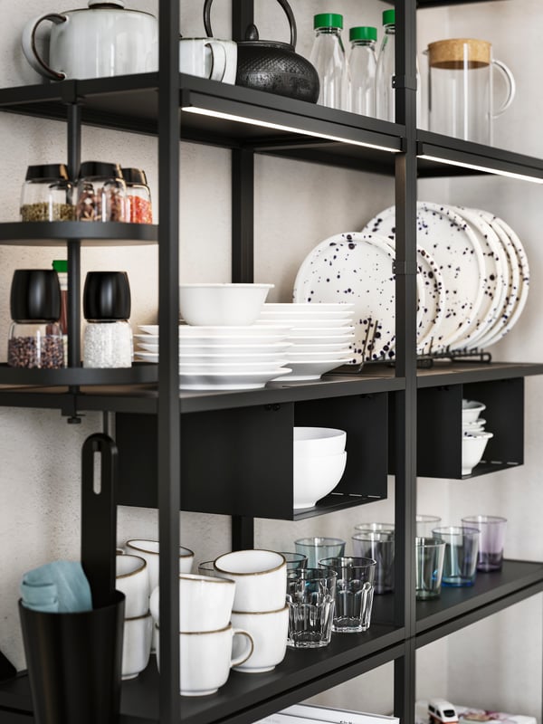 Two anthracite ENHET high frames with shelves holding various tableware, plus an anthracite ENHET swivel shelf with spices.