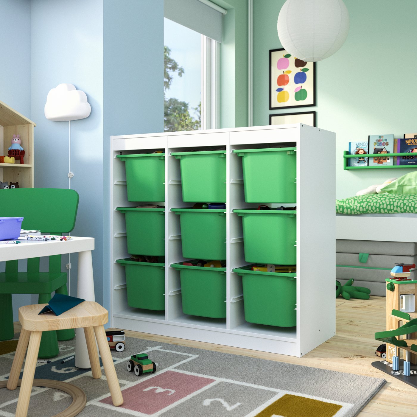 A room divider/white bright green TROFAST storage combination with boxes in the childrens room