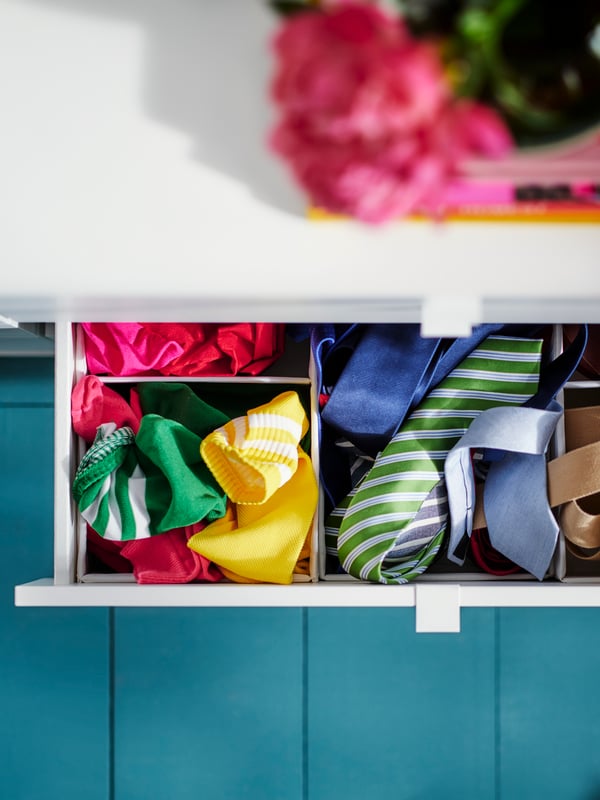 VIHALS unit with a messy open drawer, socks and ties are scattered in the drawer.