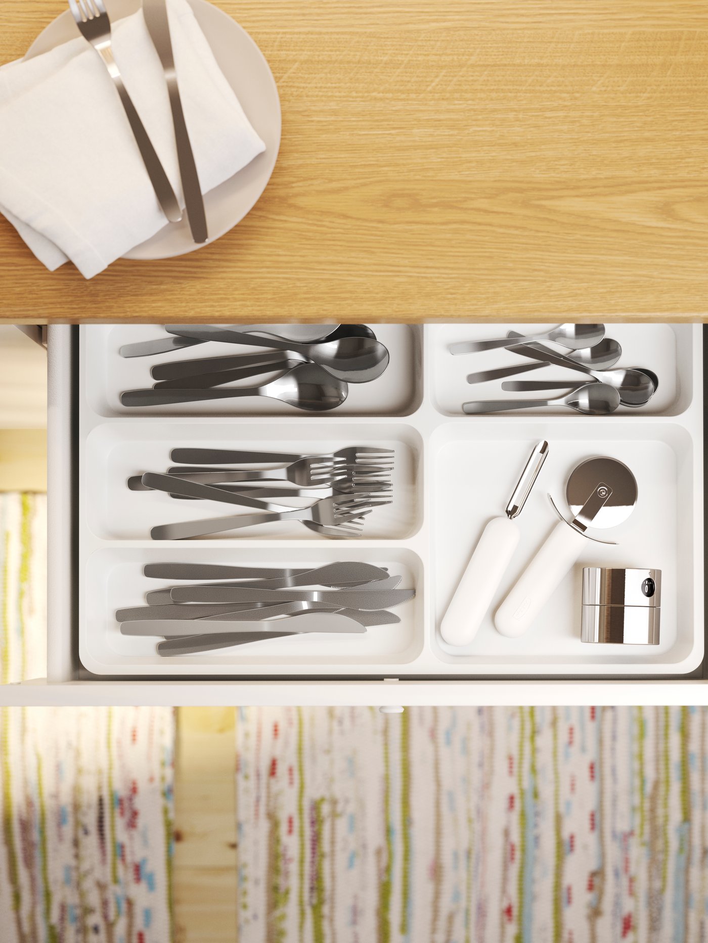 A black and white striped place mat with a napkin on it holding a knife, two forks and two spoons from a DRAGON cutlery set.