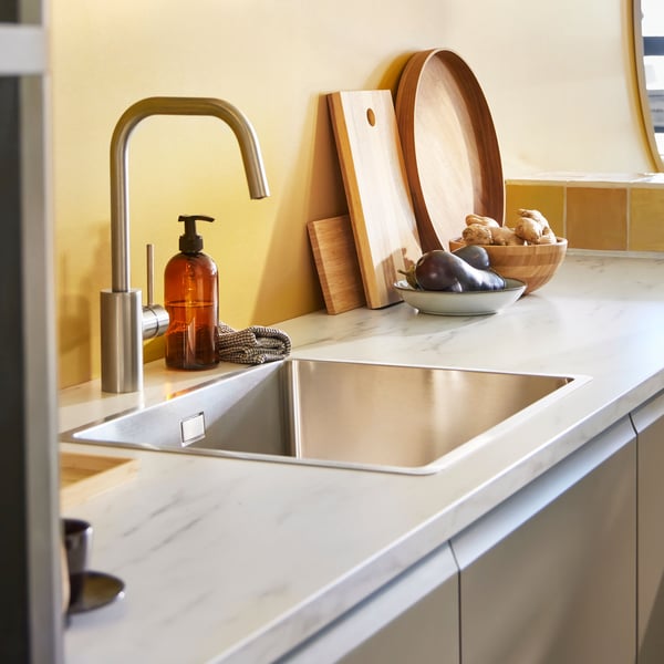 A kitchen counter with a stainless steel sink.
