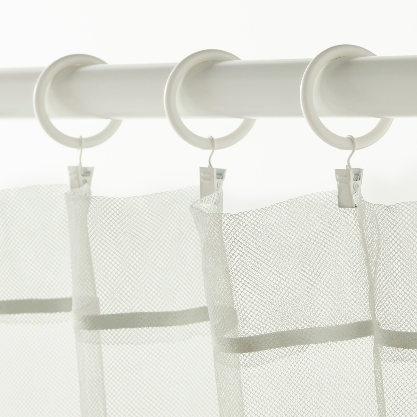A white SYRLIG curtain ring with clip and hook