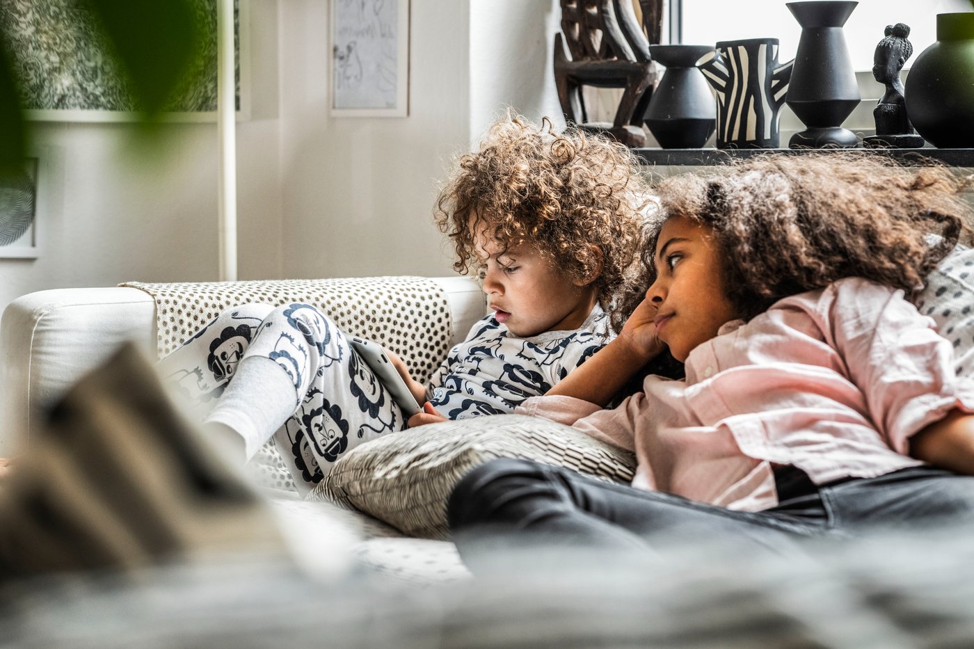 Two kids are reading a book