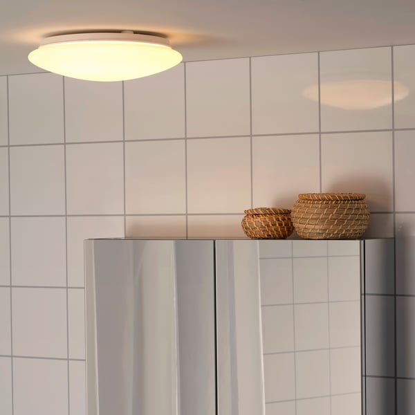 A white BARLAST LED ceiling/wall lamp in the bathroom