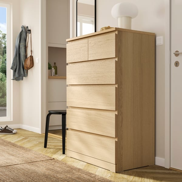 A white stained oak veneer MALM chest of 6 drawers in the hallway