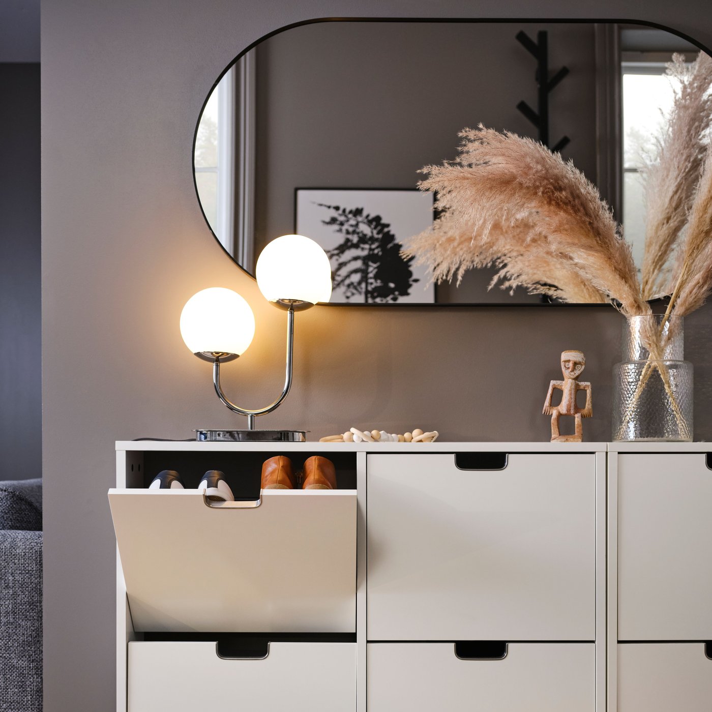 Two white STÄLL shoe cabinets with 4 compartments side-by-side with one top compartment open showing two pairs of shoes.