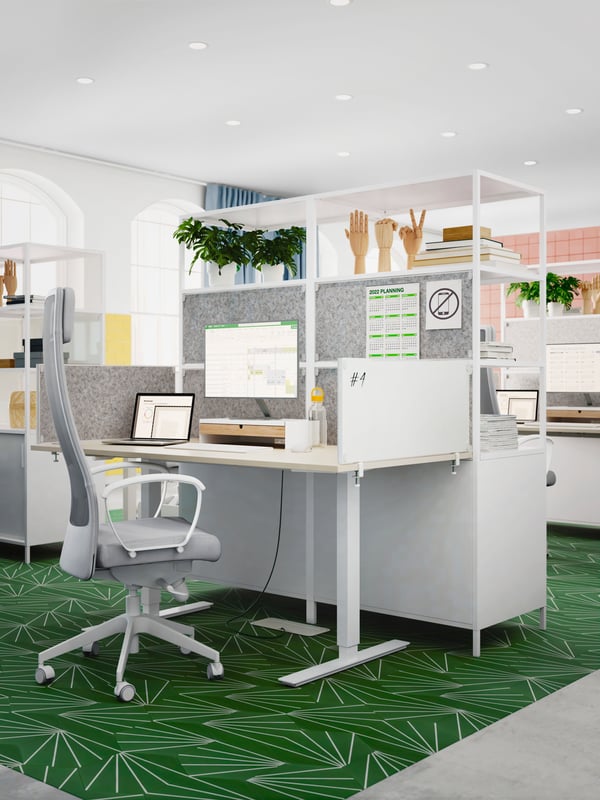 A MARKUS office chair, TROTTEN sit/stand desk and TROTTEN cabinets with sliding doors are in a light and airy office.