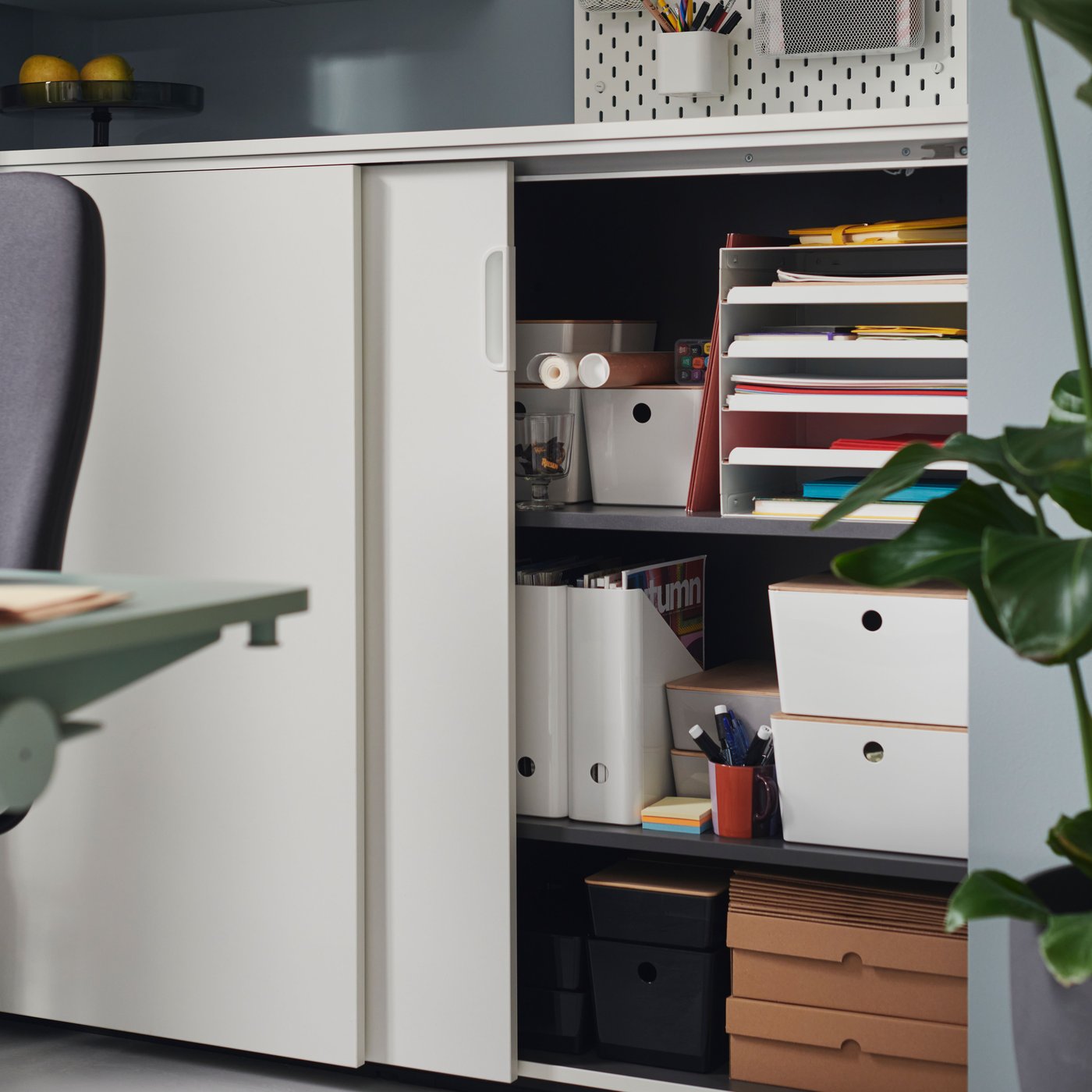 A white GALANT cabinet with sliding doors in the home office