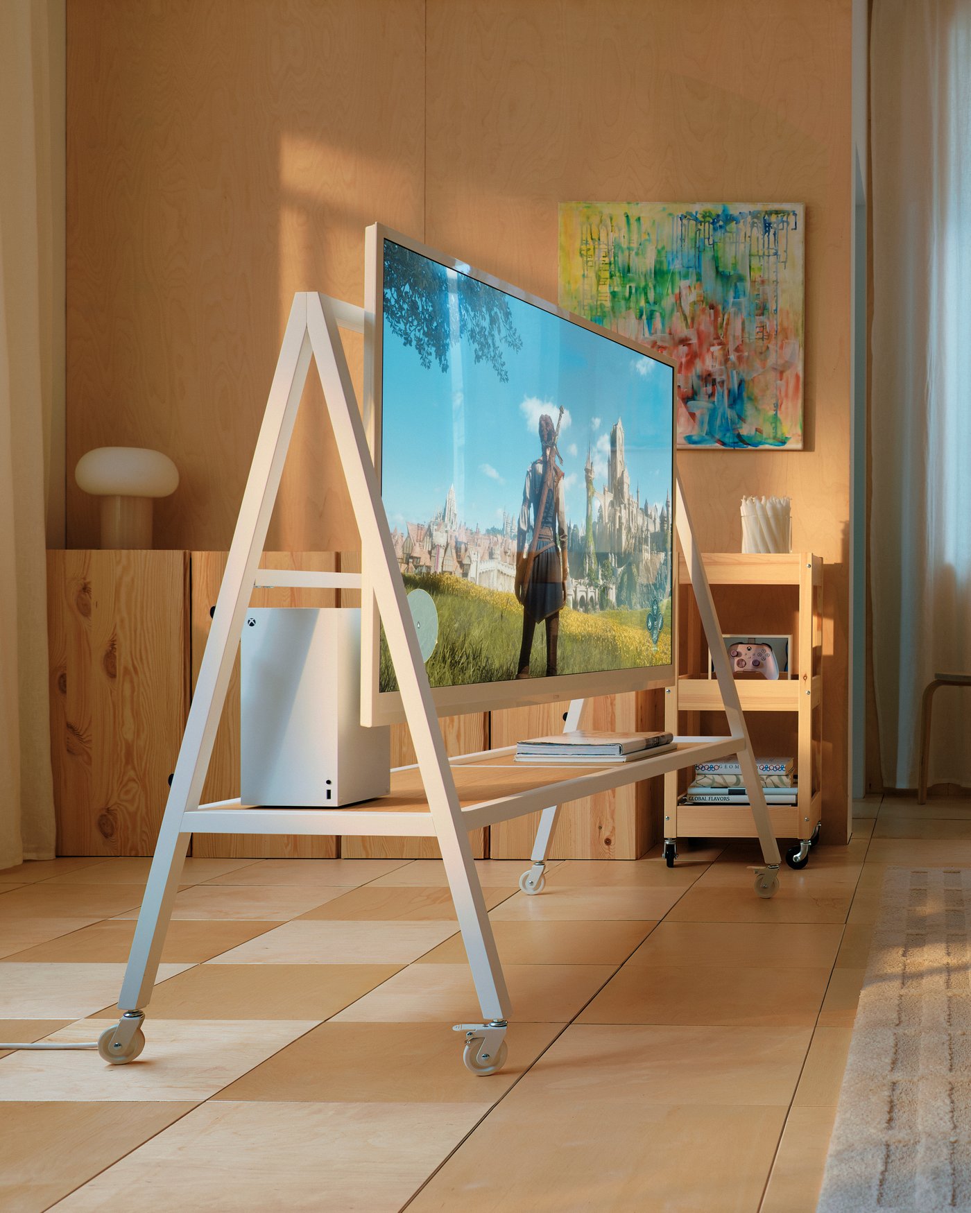 A white YXSTABY gaming tv stand on castors in the living room