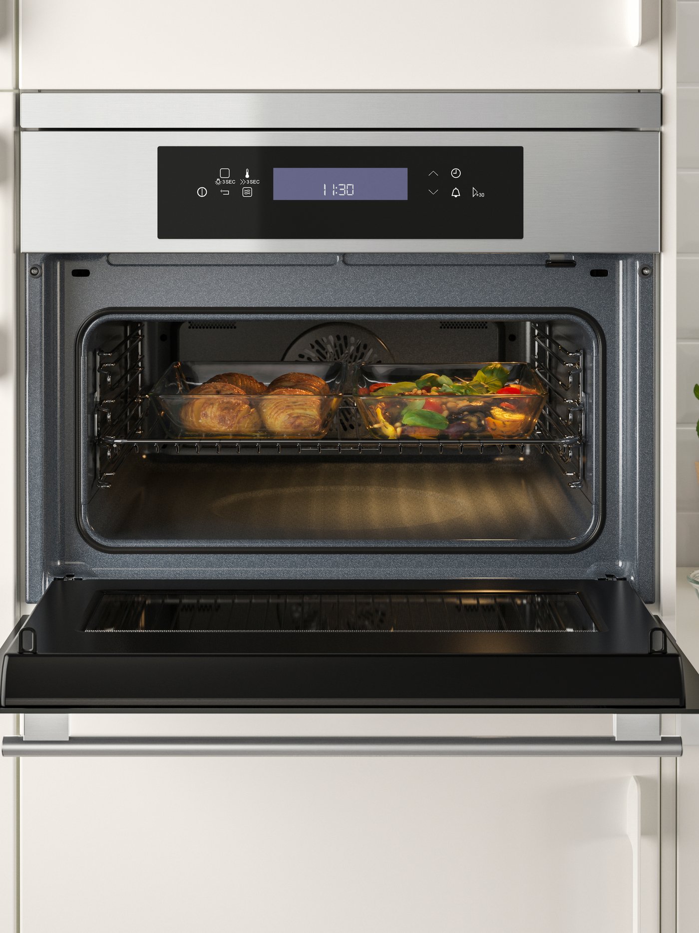 An IKEA 700 KULINARISK microwave combi with forced air in a white kitchen cabinet.
