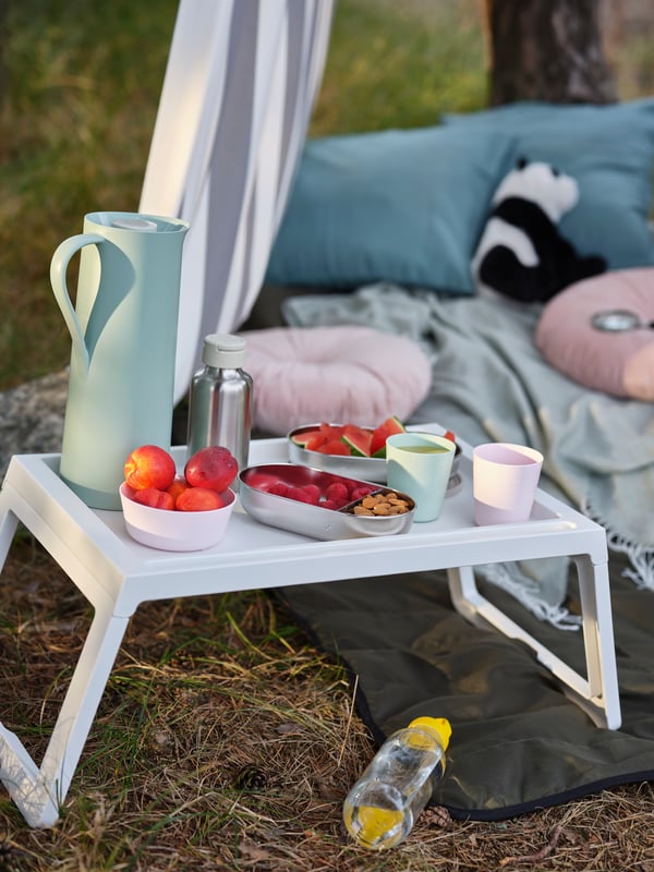 A light green/beige BEHÖVD vacuum flask outside