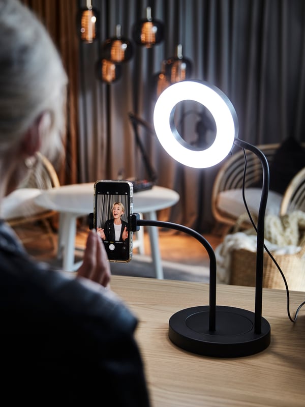 Une femme regarde un anneau lumineux LÅNESPELARE.