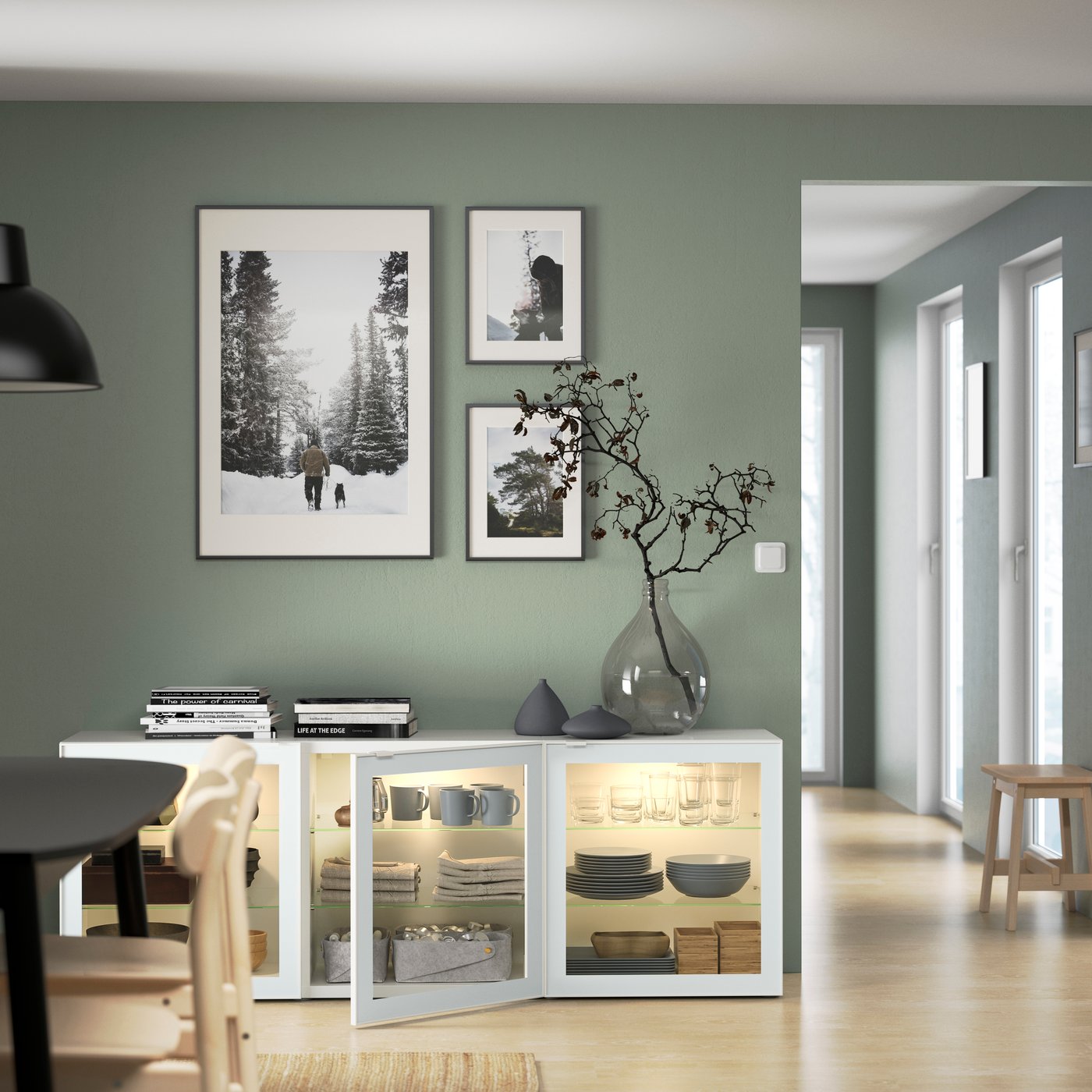 IKEA BESTÅ display cabinets in white with three glass doors filled with dishes and glassware