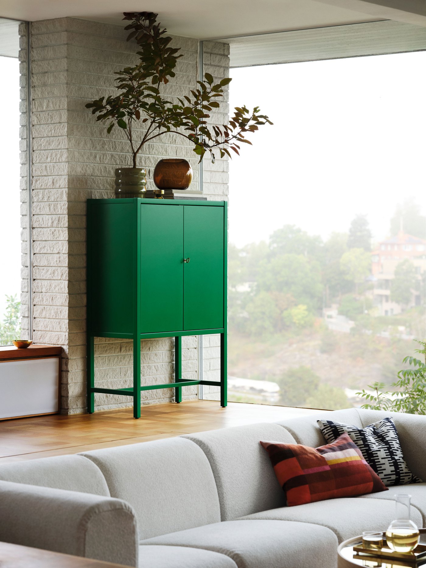 A green STOCKHOLM 2025 cabinet with 2 doors in the living room