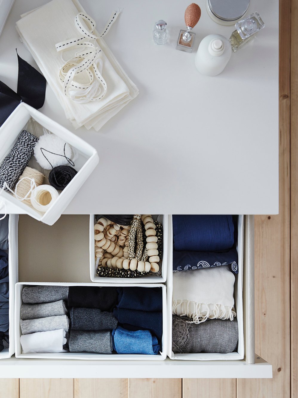 A white SKUBB box in the bedroom
