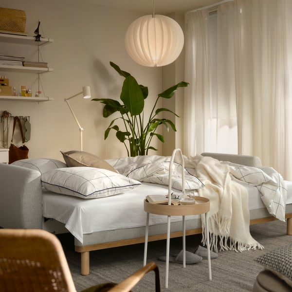 A Gunnared beige GRUNNARP 3-seat sofa-bed in the living room