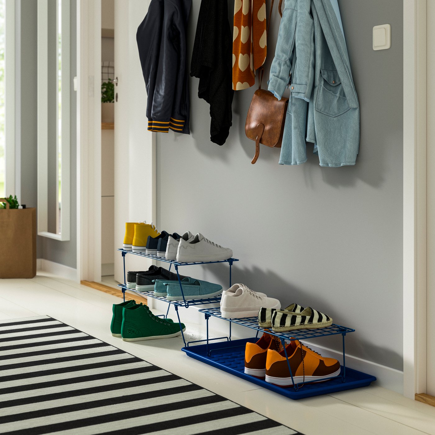 A blue GREJIG shoe rack in the hallway