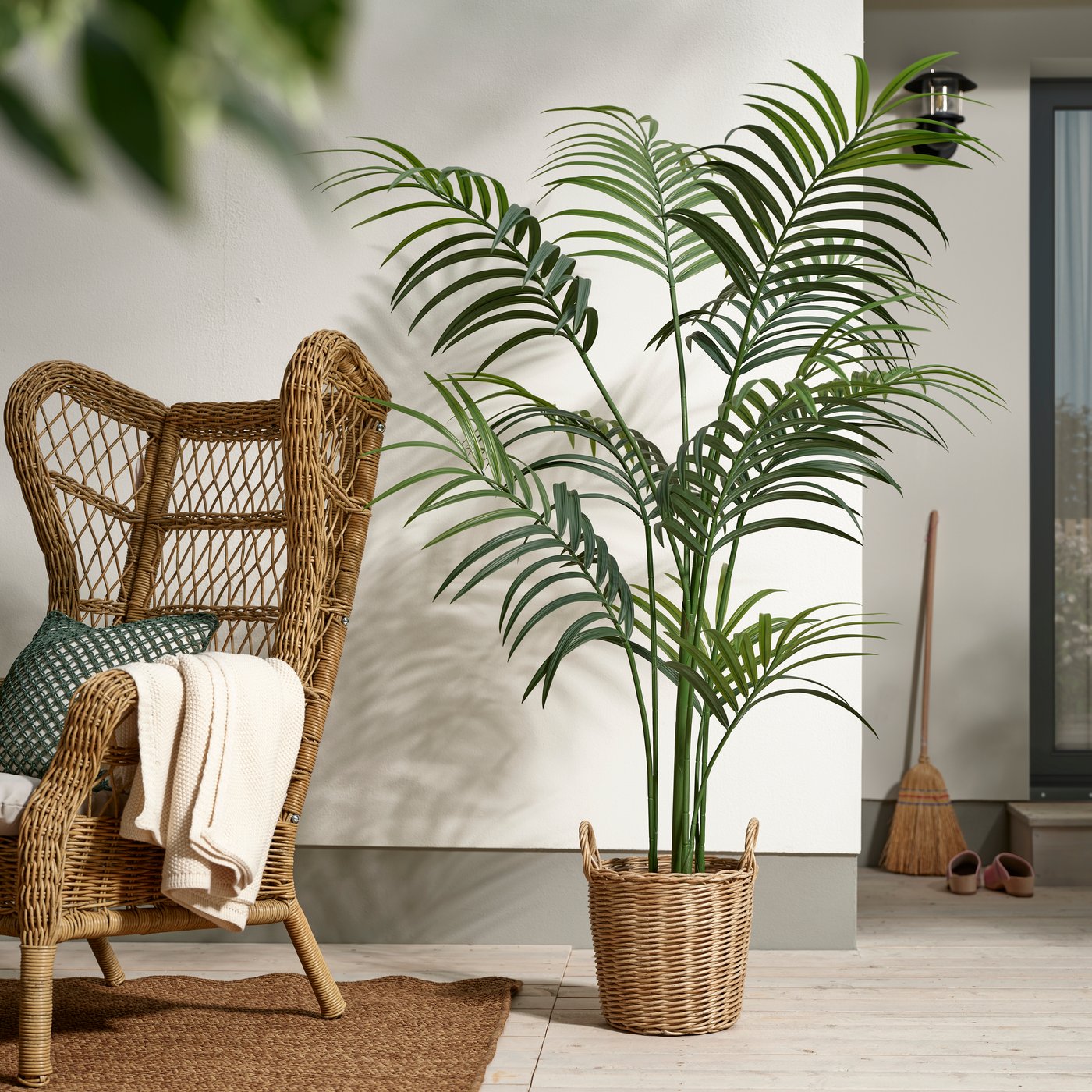 An in/outdoor/Kentia palm FEJKA artificial potted plant outside