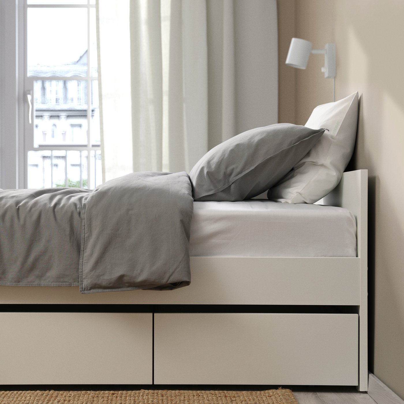 A white/Luröy VIHALS bed frame with 2 storage boxes in the bedroom