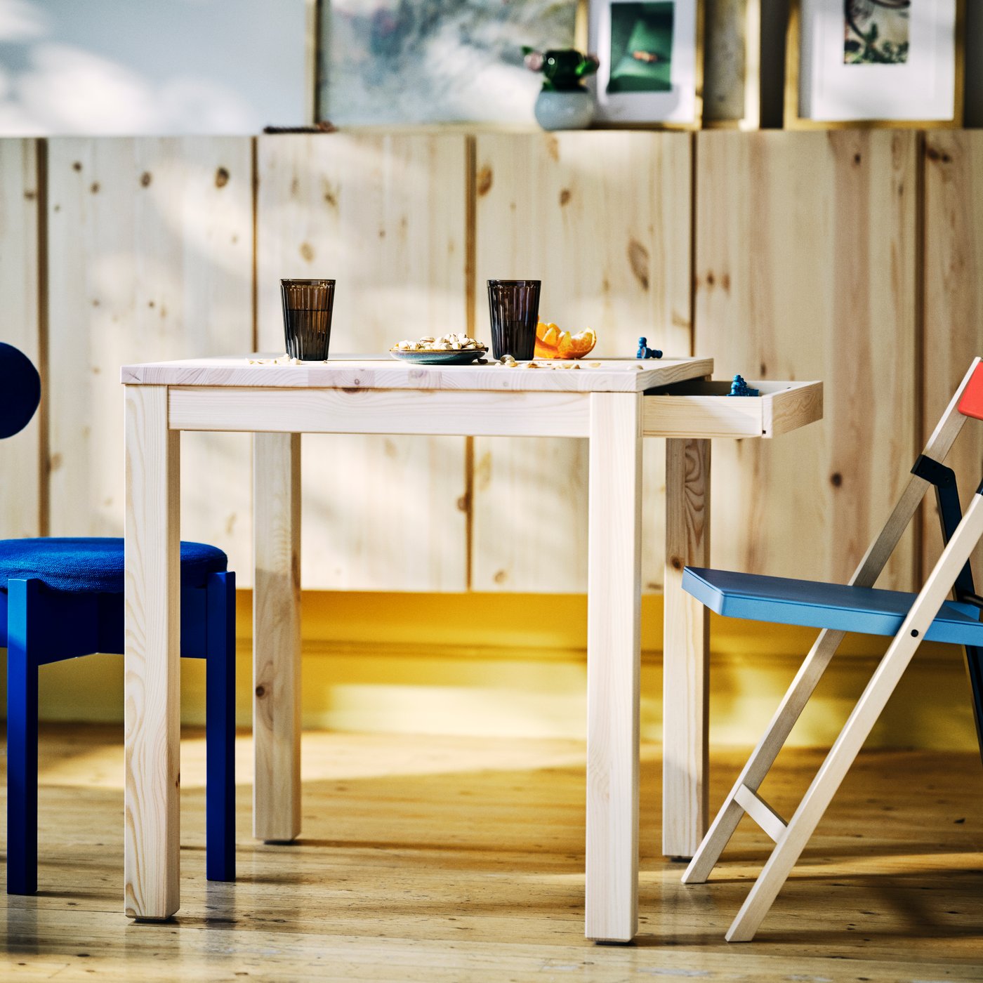 A birch blue/black red IKEA PS 2026 folding chair in the dining room