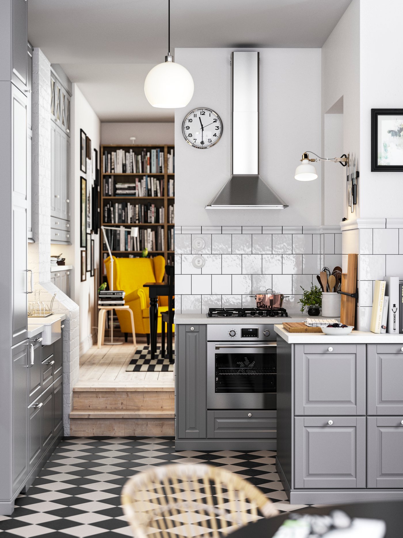 A traditional kitchen with a chequered floor, grey BODBYN kitchen fronts and white/light grey stone effect/laminate worktops.