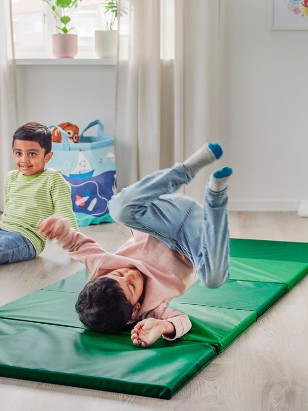 A green PLUFSIG folding gym mat