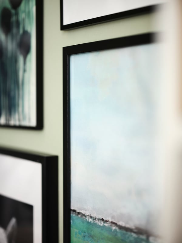 A close up of a Horizons BILD poster in a black RIBBA frame on a wall, surrounded by other framed prints.