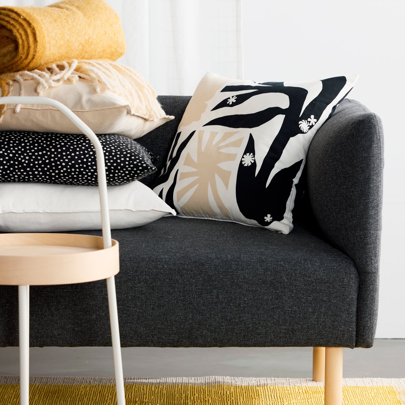 A black/white BJÖRKGRÅMAL cushion cover