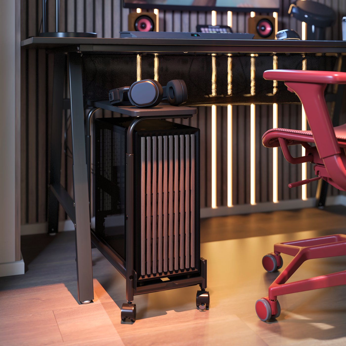 A LÅNESPELARE computer cart with shelf is under an UTESPELARE gaming desk. A red STYRSPEL gaming chair is near the cart.