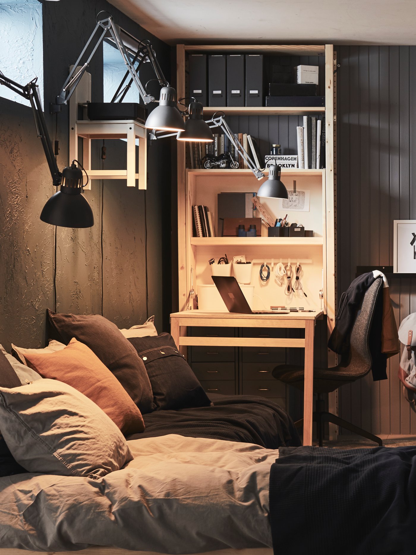 A dark grey TERTIAL work lamp in the bedroom