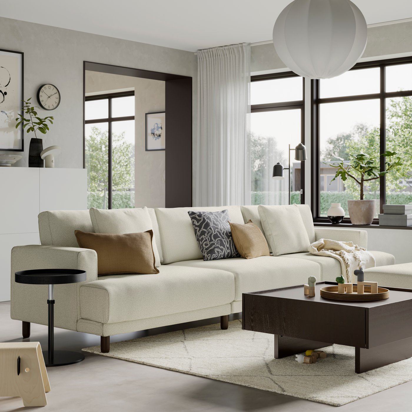 White sectional sofa with neutral and patterned accent pillows in a bright, modern living room featuring large windows, a coffee table, and minimalist décor.