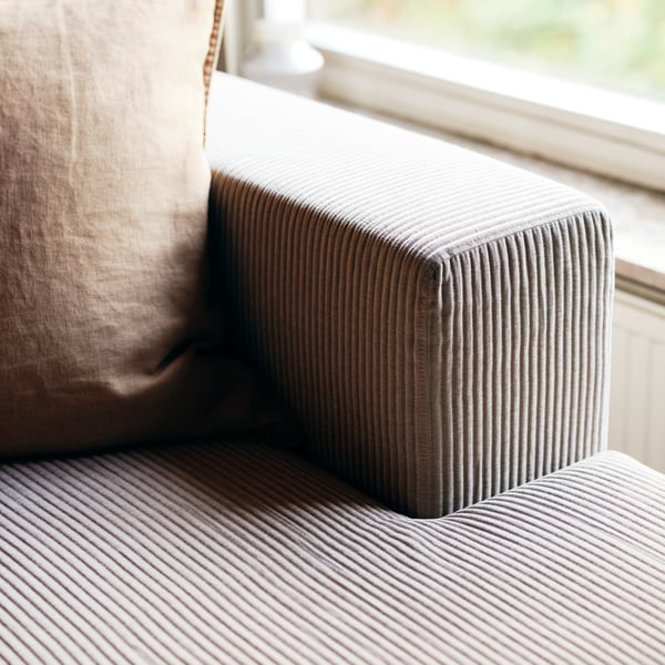 Part of a JÄTTEBO chaise longue with a grey-beige cover chaise longue module and a grey-beige cover for armrest.